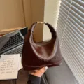 Elegant brown oil-wax leather handbag for women with stylish embossed lettering design - Coffee