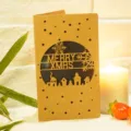 Handmade laser-cut kraft paper Christmas card with Merry Xmas and snowflake patterns - House