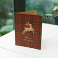 Red plaid Christmas greeting card with leaping kraft paper reindeer motif design - Deer Style / 1 Card With 1 Envelope