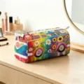 Vibrant colorful floral hippie bus makeup bag shown in a detailed lifestyle setting on a vanity. - L / 25.5*13*13cm / Rainbow Bus (09)