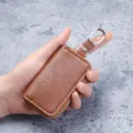 Premium brown leather mini multi-function key pouch wallet shown being held in hand - Brown