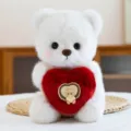 Cute white plush teddy bear holding a red heart love pillow, perfect toy gift. - Heart Style / White