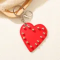 Creative red PU leather heart-shaped keychain with silver stud rivets and metal clasp - Heart
