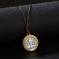 Macro shot of a vintage gold-plated round medal pendant with brown adjustable cord - Necklace / Coffee