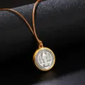 Close-up detail of a circular vintage religious medallion pendant with an adjustable brown cord - Necklace / Brown