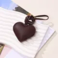 Elegant dark brown PU leather heart charm featuring fine stitching and a matching cord loop - Deep Caramel