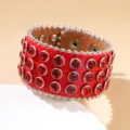 Red leather cuff bracelet with multiple rows of ruby rhinestones and silver studs - Style 1