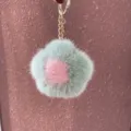 Close-up showing the soft mink fur texture of a green and pink flower keychain pendant - Smiley Version Hardware - Bean Green & Pink