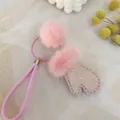 Close-up detail of a cute pink mink fur pom and glittery mitten keychain bag charm - Pink Star Dots