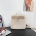 Close-up of a soft beige faux fur backpack with stylish metal zipper details - Apricot
