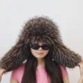 Detailed view of an oversized faux raccoon fur trapper hat featuring a Y2K aesthetic - Coffee