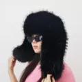 Close-up of a black oversized fluffy faux fur ushanka hat in a trendy Y2K aesthetic style. - Black