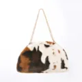 Large faux fur cloud clutch bag with mottled pattern and gold chain strap - Cow Print