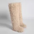 Detail view of shaggy cream faux Mongolian lamb fur on stylish over-the-knee snow boots - 36 / Apricot