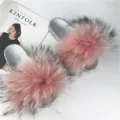 Detail of luxury pink raccoon fur on stylish silver PVC slides for women - Red Base with Black Tips