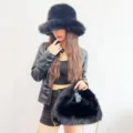 Detailed look at the fluffy faux fox fur bucket hat and matching hobo bag set in black - Set / Black