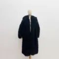 Detailed view of women's black faux Mongolian sheepskin fur coat featuring a plush lapel collar - S / Black