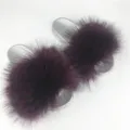 Luxury silver PVC slide slippers featuring oversized burgundy raccoon fur decorative pom-poms - Burgundy