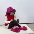 Detail view of hot pink faux fur bucket hat and matching slippers set worn by a model. - 36 (US 3) / Rose Red