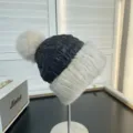 Detail of women's quilted down hat with white mink fur brim and fluffy fox fur pom pom - One Size / Beige Black