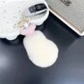 Close-up detail of a soft plush chicken drumstick keychain with fluffy white faux fur. - 12cm / Off White