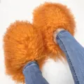 Close-up of vibrant orange Mongolian fur slides worn with blue jeans - 5 (Shoe Length 250, Inner Length 225) / Orange