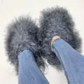 Detailed close-up view of fluffy grey Mongolian fur slippers worn with blue jeans. - 5 (Shoe Length 250, Inner Length 225) / Dark Gray