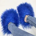 Vibrant blue curly Mongolian fur slides paired with denim jeans on white floor. - 5 (Shoe Length 250, Inner Length 225) / Sapphire Blue