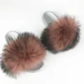 Stylish women's silver PVC slides featuring large fluffy brown and black raccoon fur pom-poms - Dark Mauve