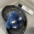 Macro view of blue mink fur bunny keychain with plush texture and golden metal ring - Deep Sea Blue