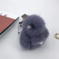 Close-up detail of a fluffy 8cm purple mink fur rabbit keychain on minimalist background. - Blue Gray