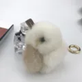 Macro detail of the fluffy mink fur rabbit charm with soft white and beige fur textures. - White with Khaki Ears
