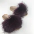 Stylish golden PVC base slides featuring luxurious fluffy deep purple raccoon fur straps. - Burgundy
