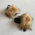 Detailed view showing the fluffy faux fur texture on these black kids' sandals with straps - 4C / Brown