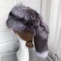 Close-up detail of a silver fox fur hat with a long decorative tail for winter warmth. - Silver Fox