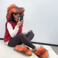 Model wearing punk style faux raccoon fur hat and matching fluffy slippers set. - 36 (US 3) / Orange - (Faux Wool Sole 2.0 & Hat Set)
