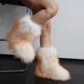 Detailed view of fluffy white and orange faux raccoon fur Y2K style snow boots for women - 38 / White Base Orange Tip