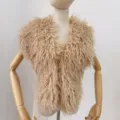 Detailed close-up view of champagne faux Mongolian sheep fur halter top on a display mannequin - One Size / Khaki