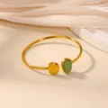 Detailed shot of an open gold stainless steel bracelet with green stone and disc. - One End Green Gem One End Disc Style (B2027G)