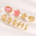 Multi-piece gold ring set featuring pink baroque pearl, flower, starfish and shell designs. - Floral Ocean Set (4098)