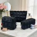 Set of three black quilted puffer cosmetic bags displayed on a luxury marble vanity - Medium (17*7.5*13cm) / Black