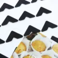 Detail shot of black photo corner stickers, perfect for scrapbooking, DIY crafts. - Black with White Background