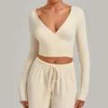 Beige wrap yoga long sleeve crop top with matching drawstring lounge pants for active workouts. - Cream Apricot