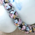 Handmade glass floral beads detail close up, colorful petal pattern DIY jewelry accessory - Black