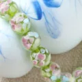 Close-up detail of handmade floral glass beads, green translucent petal design for DIY jewelry. - 12mm / Yellow-Green
