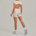 Open-back beige yoga set featuring a short-sleeve crop top and matching tight fitness shorts. - S / Top And Bottom / Warm Stone Grey