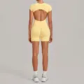 Yellow backless yoga set two-piece outfit with slim pleated shorts for fitness and casual wear. - Durian Yellow