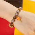 Tibetan style cinnabar glazed bead bracelet with cute orange drum charm for women daily wear. - Manjushri Heart Mantra