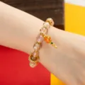 Tibetan cinnabar glass bead bracelet with gold prayer wheel pendant, lucky wrist jewelry for women. - Yellow Dzambhala Heart Mantra