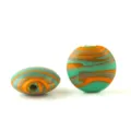 Closeup of frosted mixed silk antique glass beads with green orange swirl patterns for DIY jewelry. - L Green & Orange Intermingled Flat Round